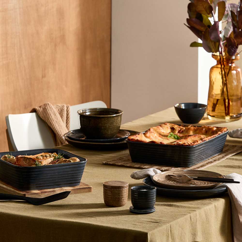 dining table with moody ribbed rustic dinnerware, bakeware, and kitchenware - House
