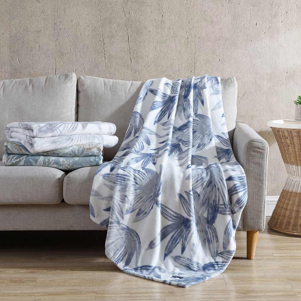 Tommy Bahama Kayo Throw Canal Blue draped over a couch at House