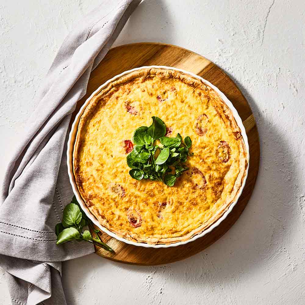 Alex Liddy Classic Quiche Dish 27cm White on a wooden trivet at House