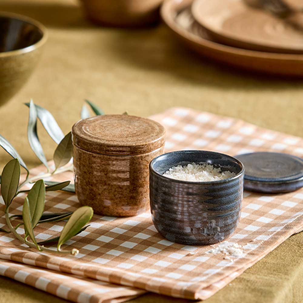 Salt And Pepper Pinch Pots in navy and brown sitting on a beige check tea towel - House