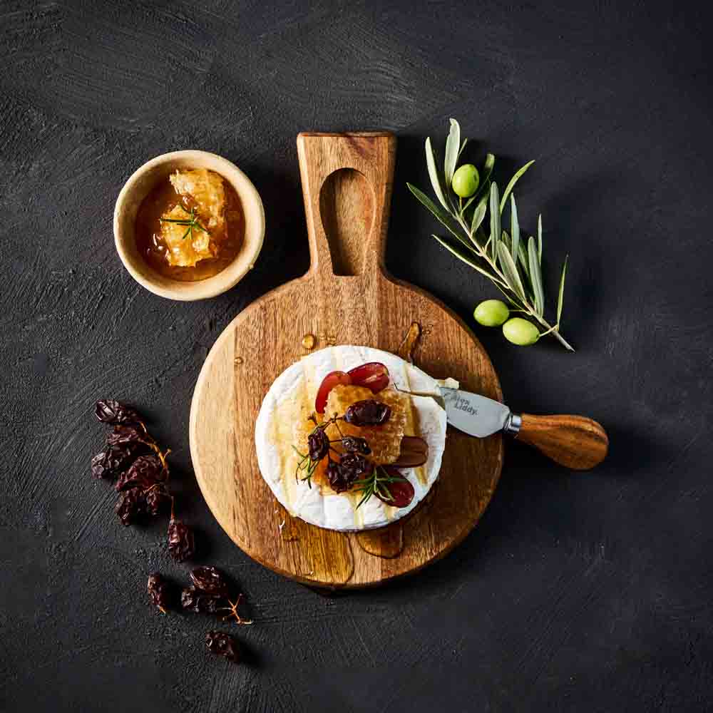 brie and honey with cheese knife on cheese board - House