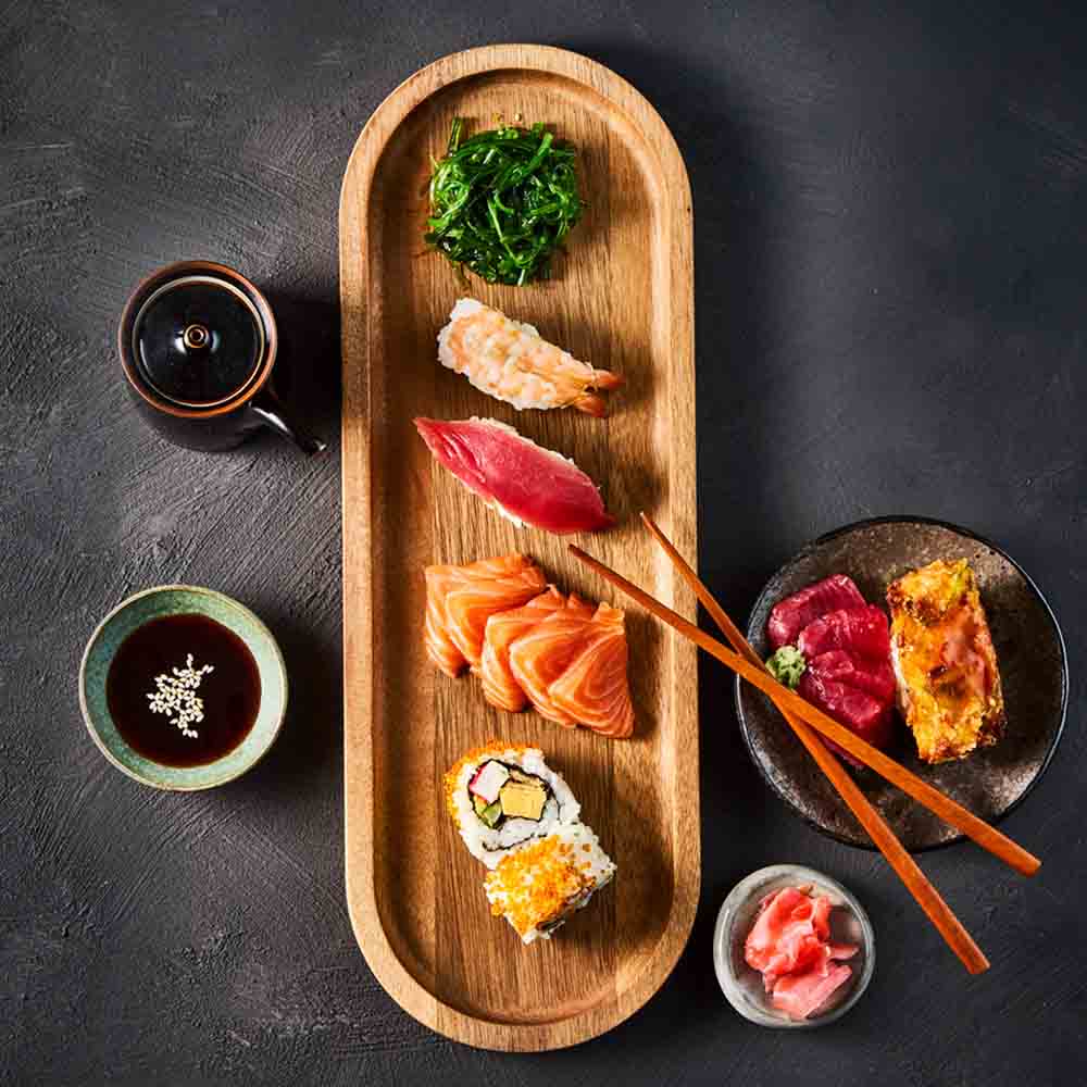 platter of sashimi on wooden board