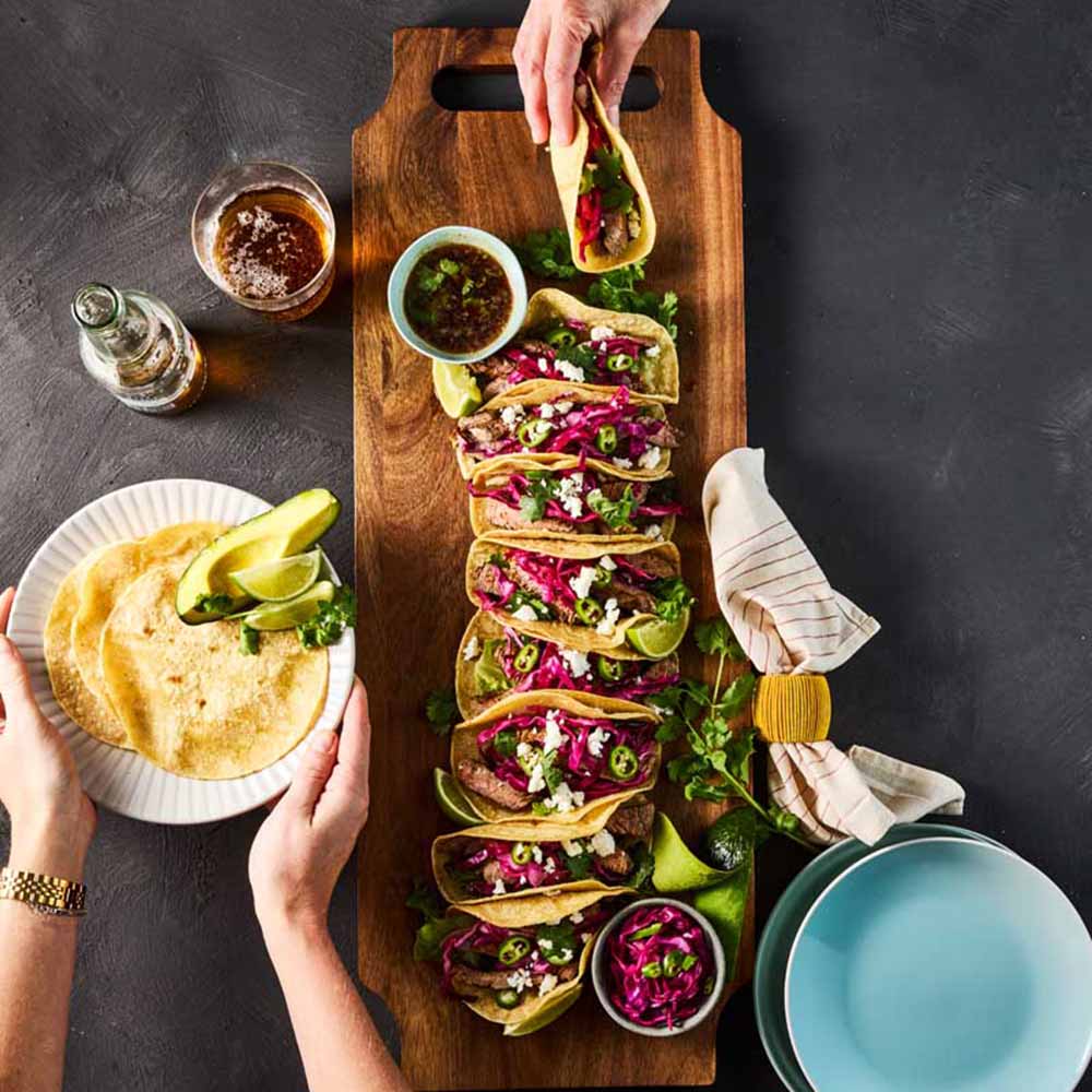 tacos on a long wooden serving board