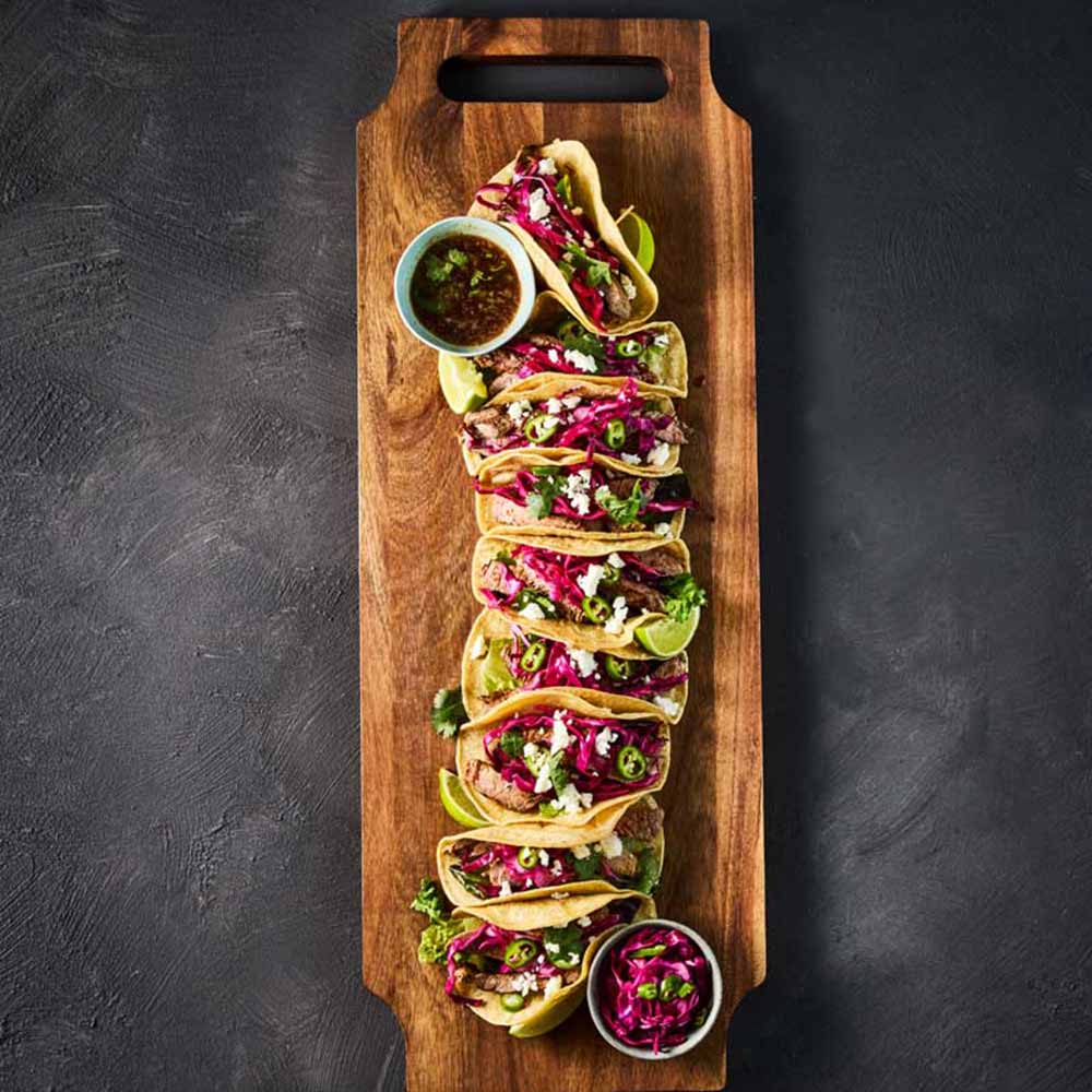 tacos on a long wooden serving board
