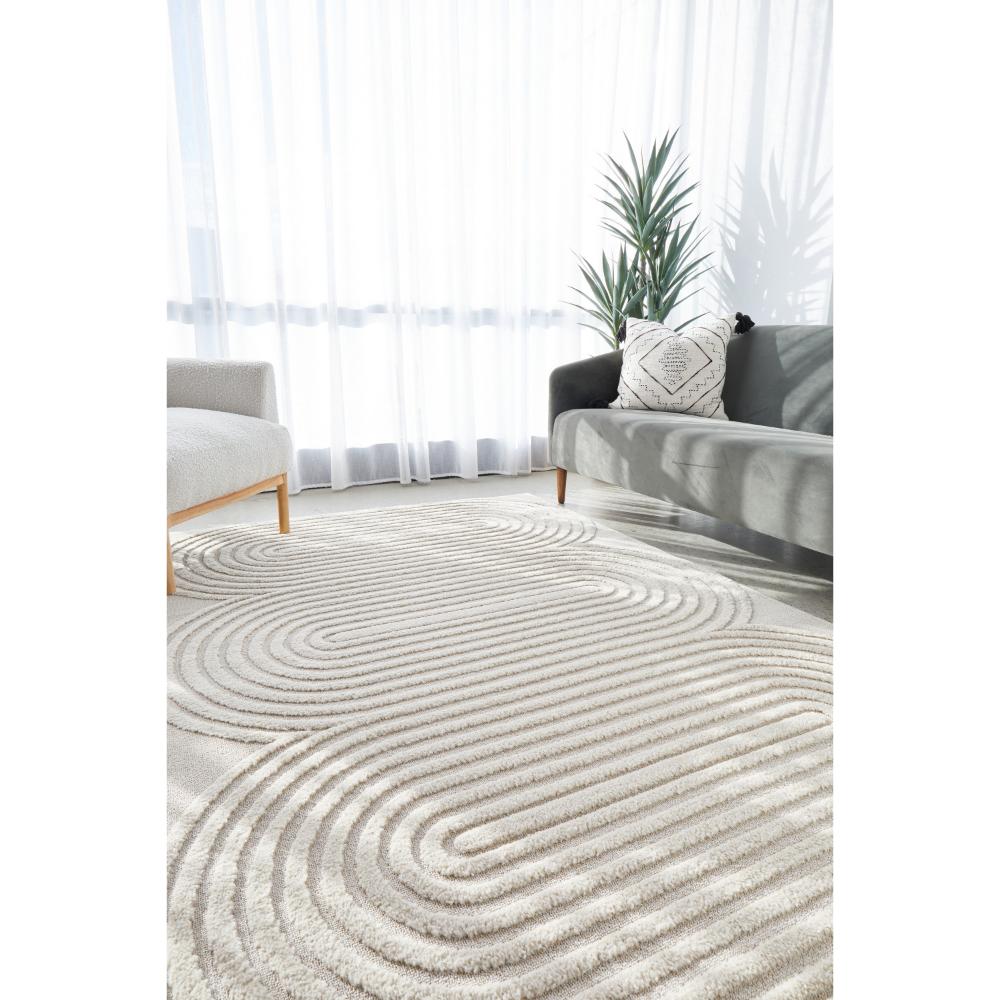 Rug Culture Lotus Carl Rug in beige at House. Rug with oval detail in lounge room