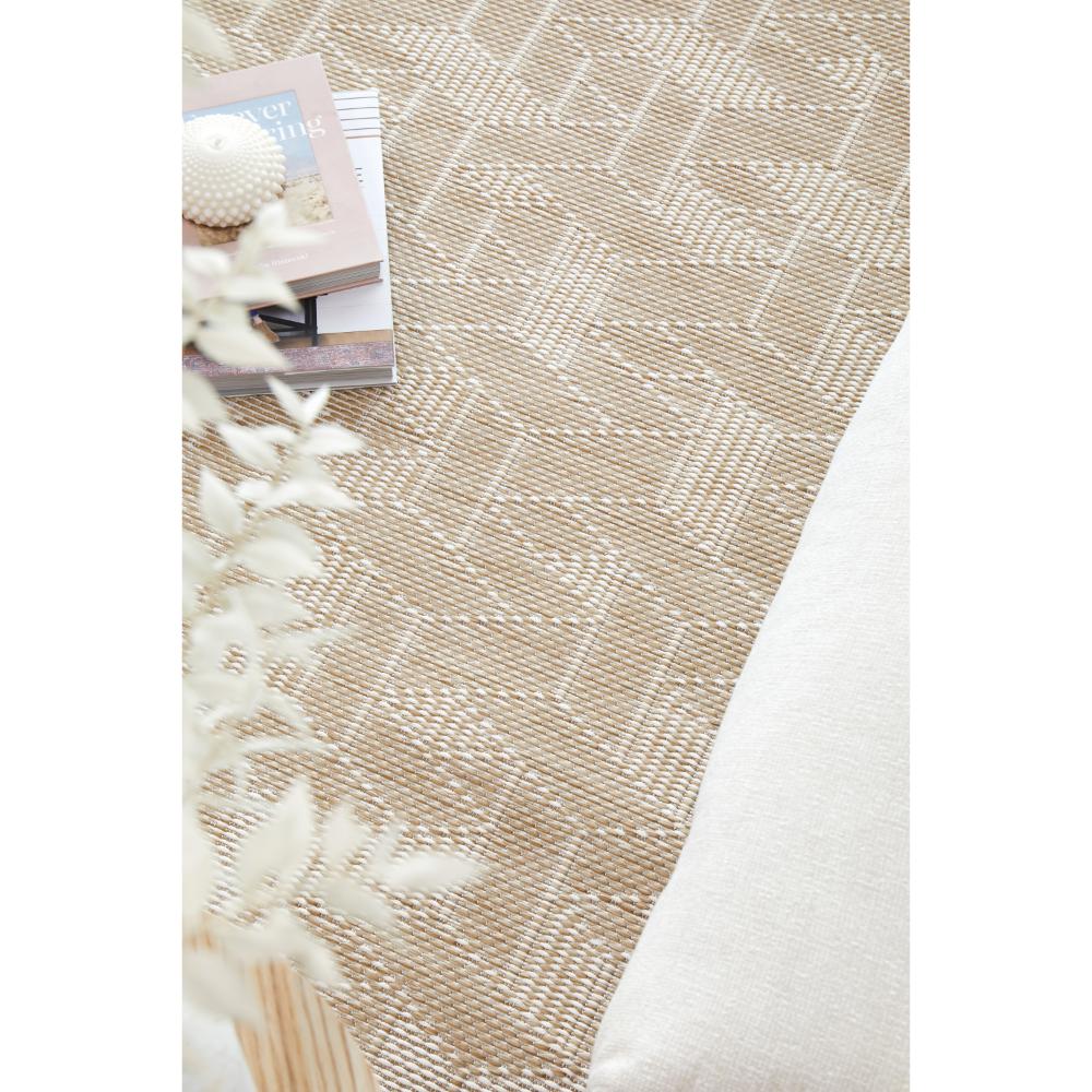 Indoor/outdoor natural weave look rug with books - House