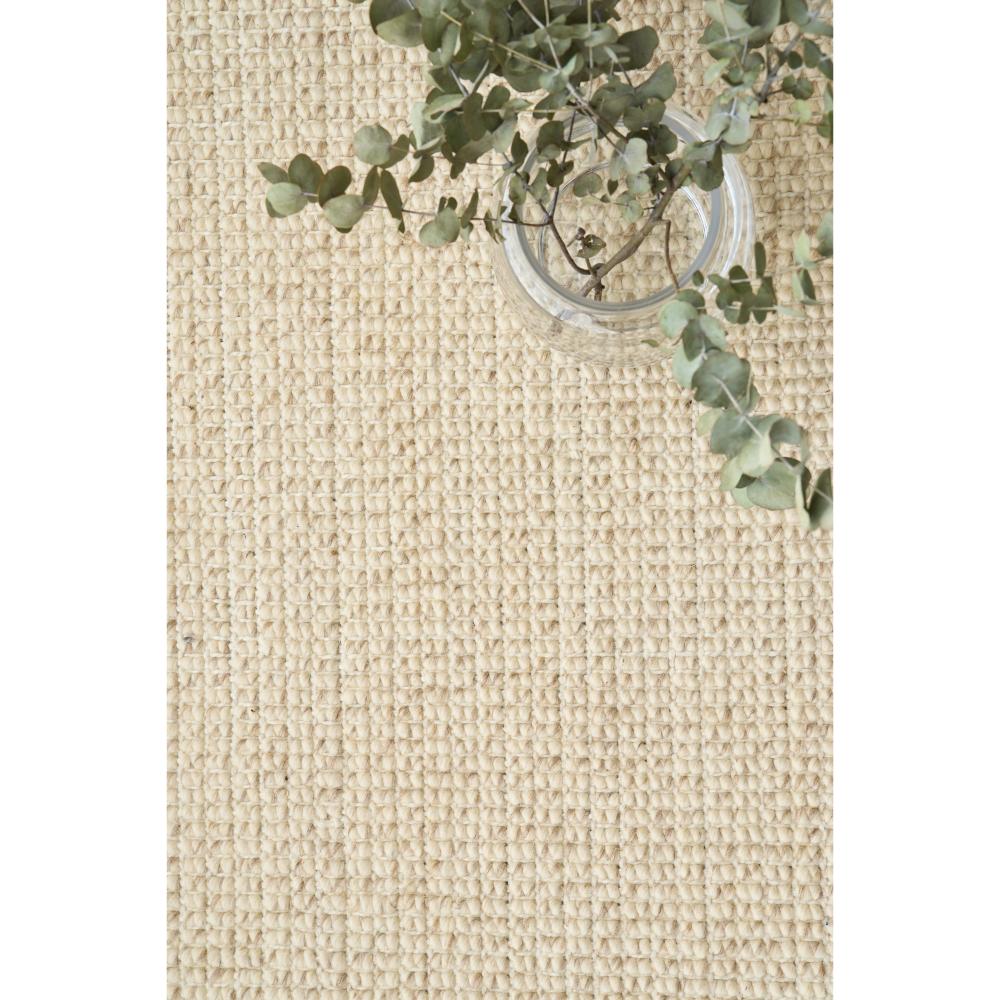 cream hamptons style jute wool rug with glass vase- House
