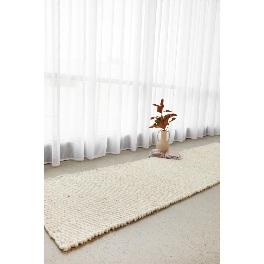 cream white Jute Hampton Rug by a window - House