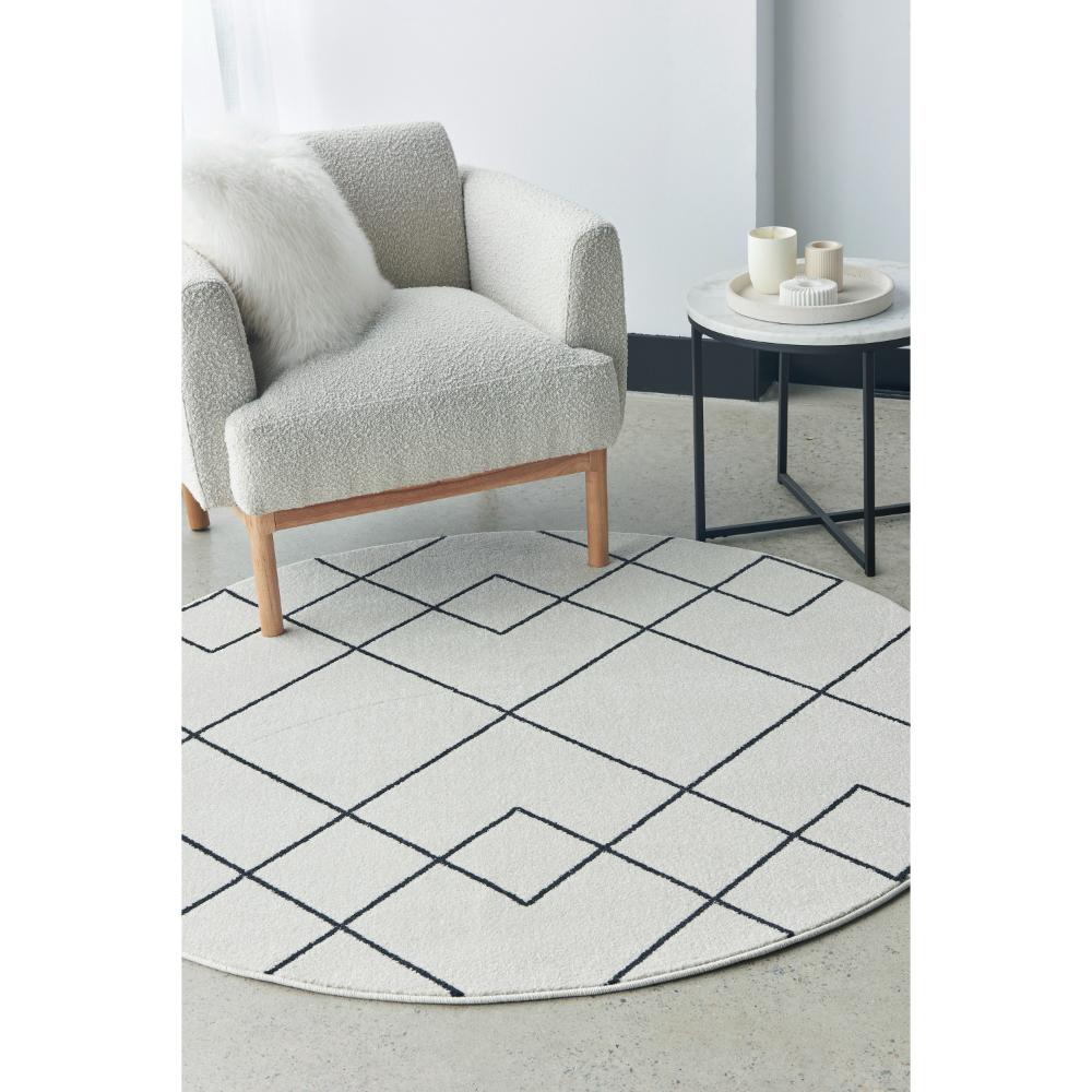 grey abstract round rug with armchair and side table - House