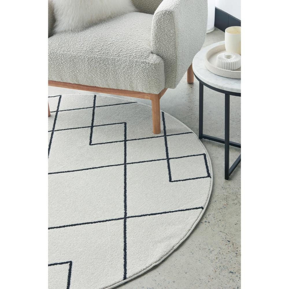 grey abstract round rug with armchair and side table - House