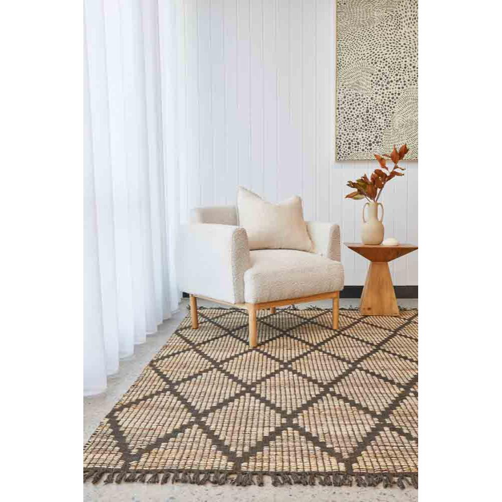 brown diamond design rug in a loungeroom with armchair - House
