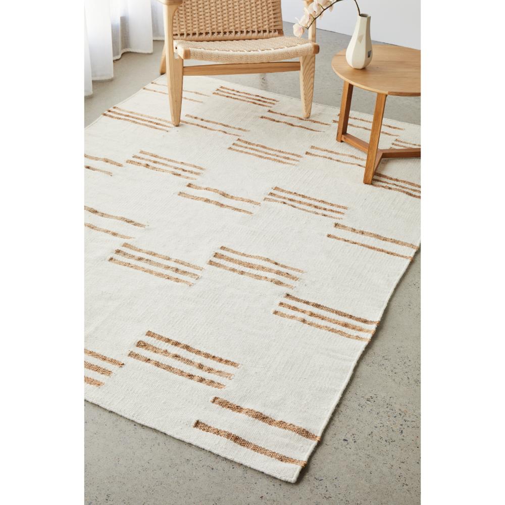 beige wool jute modern rug with armchair and table - House