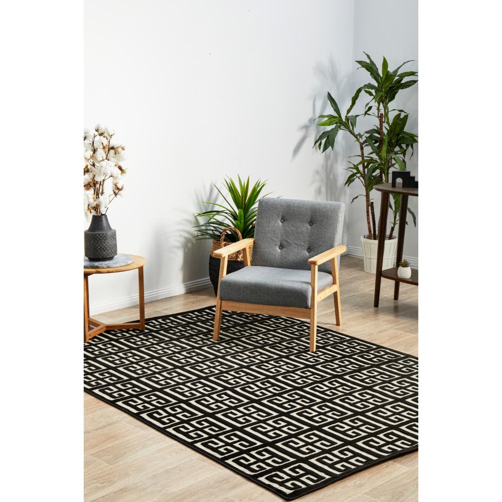 black and beige art deco tile rug with armchair and table - House