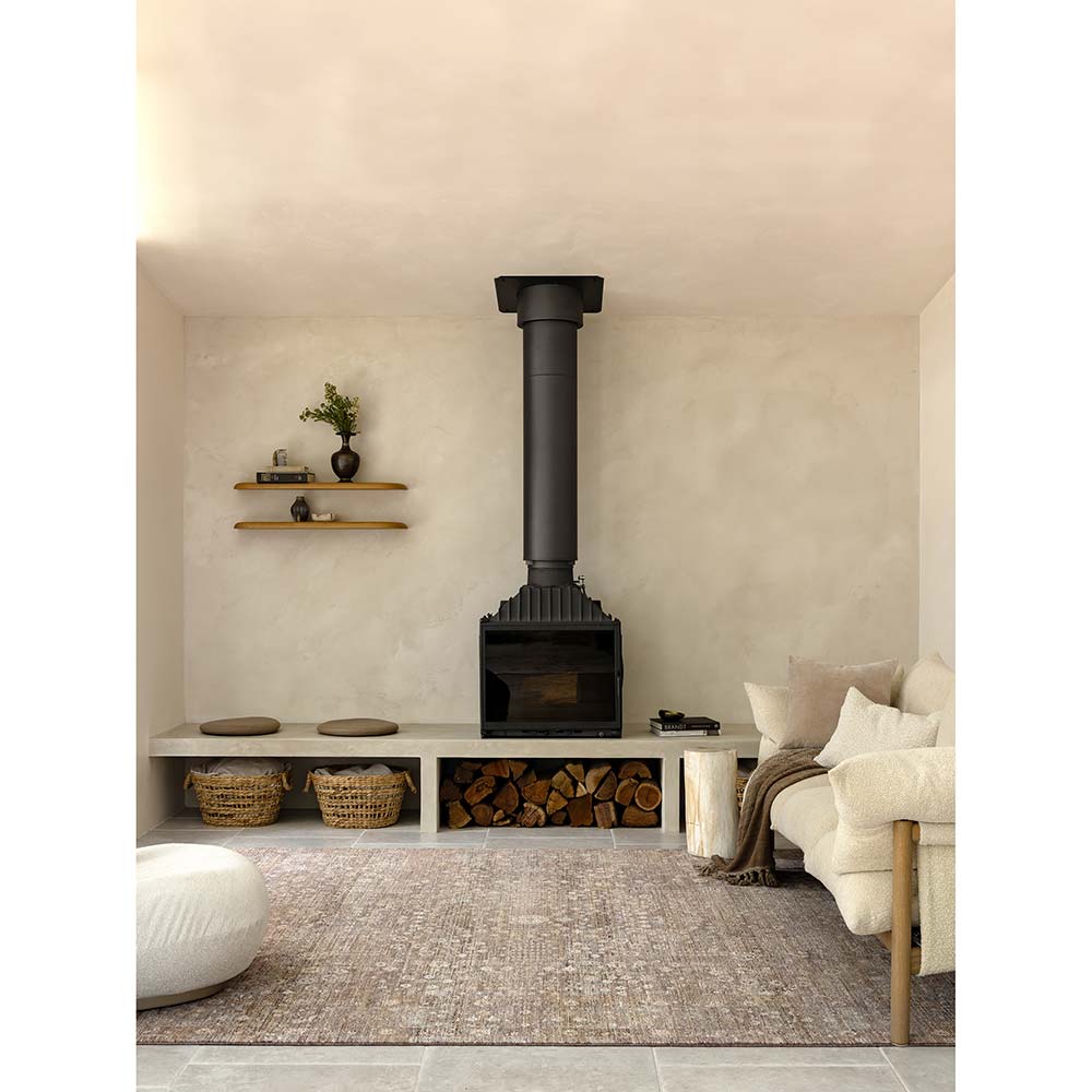 Darren Palmer Moorland Rug in Fig in a lounge setting in front of a fireplace at House
