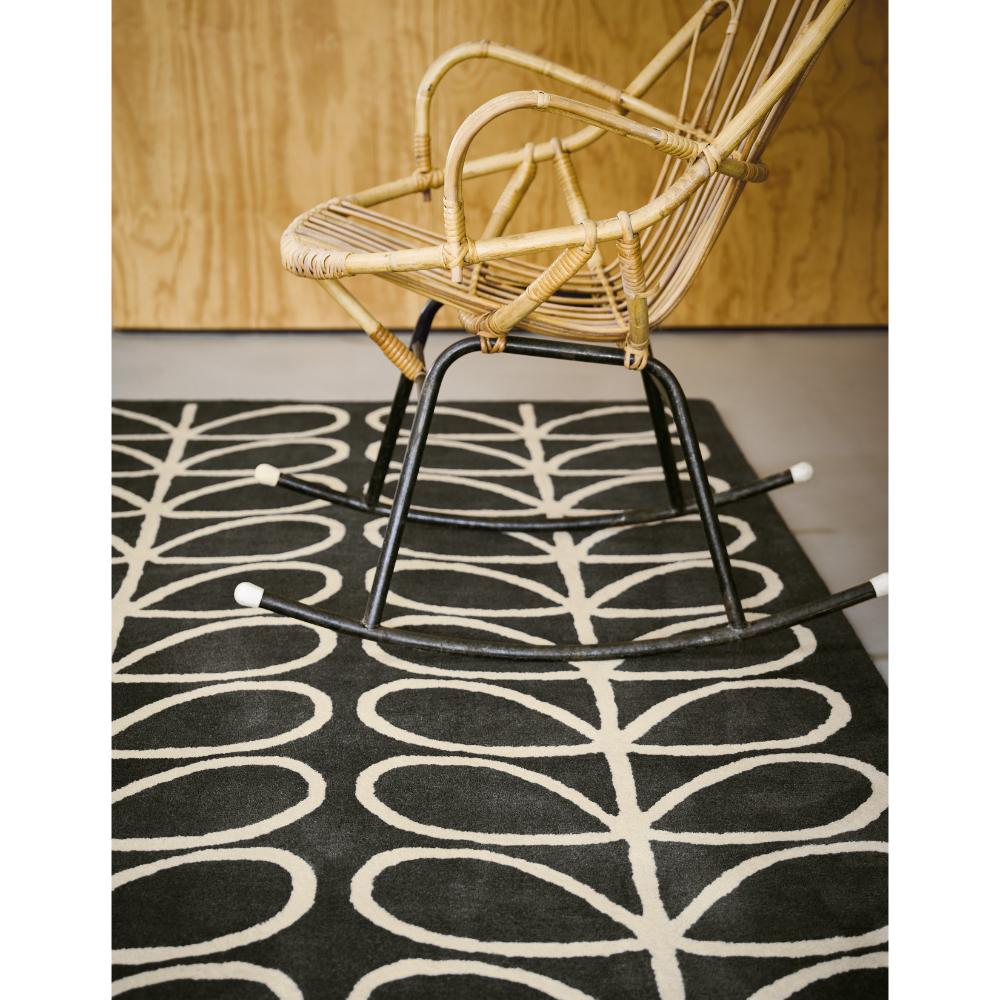 Grey Flower Stem Wool Rug with wicker rocking chair - House