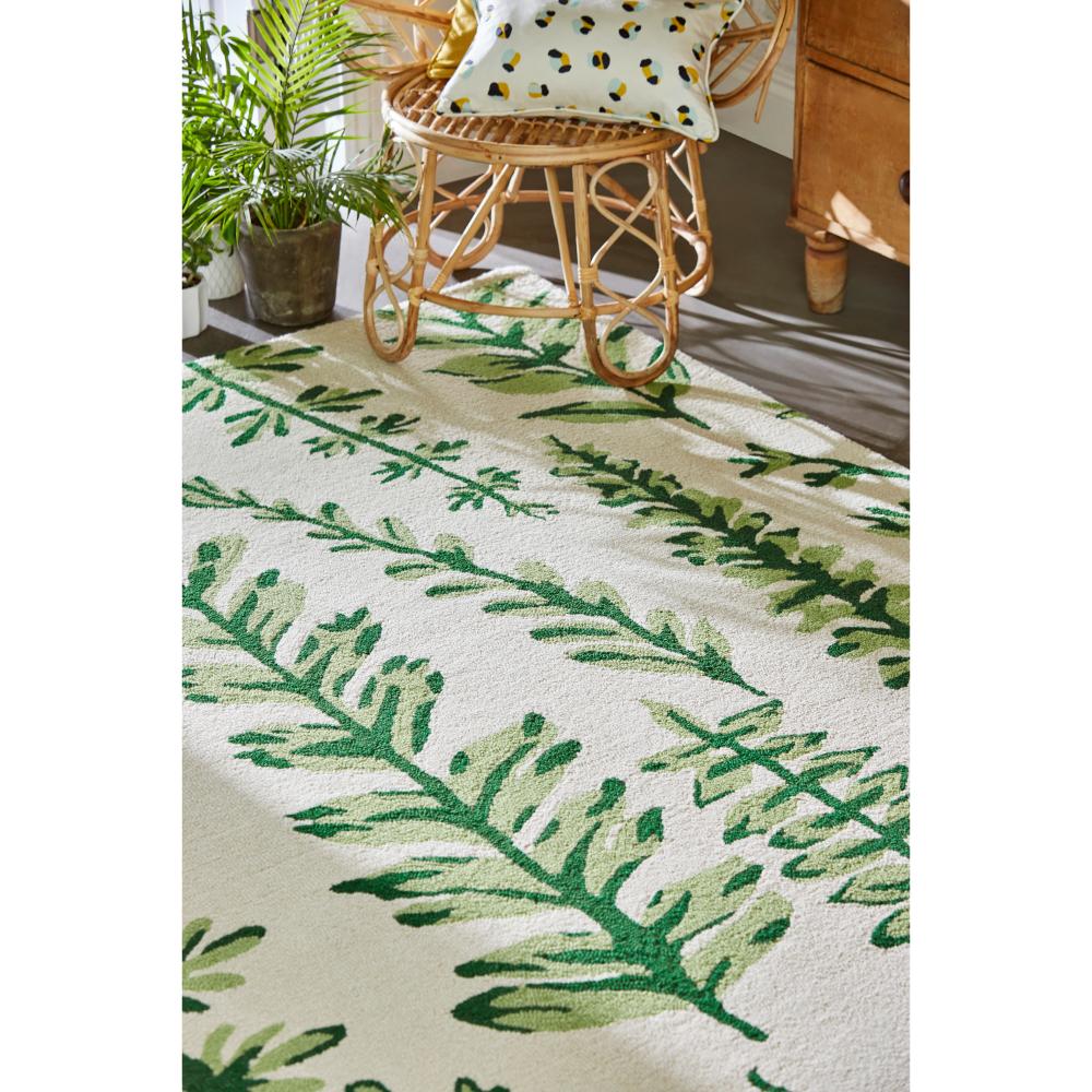Green fern wool rug with wicker chair - House