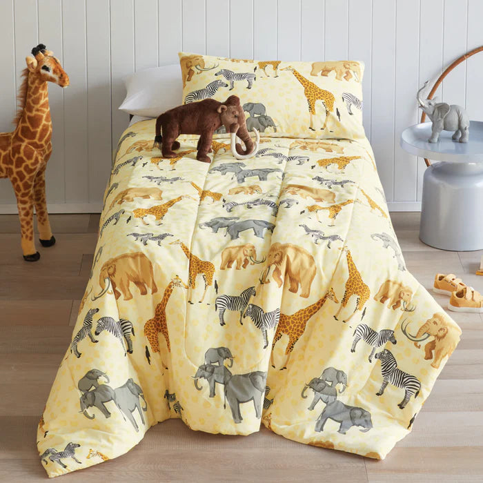 Children's bedding set with animal pattern on a bed, surrounded by stuffed animals.