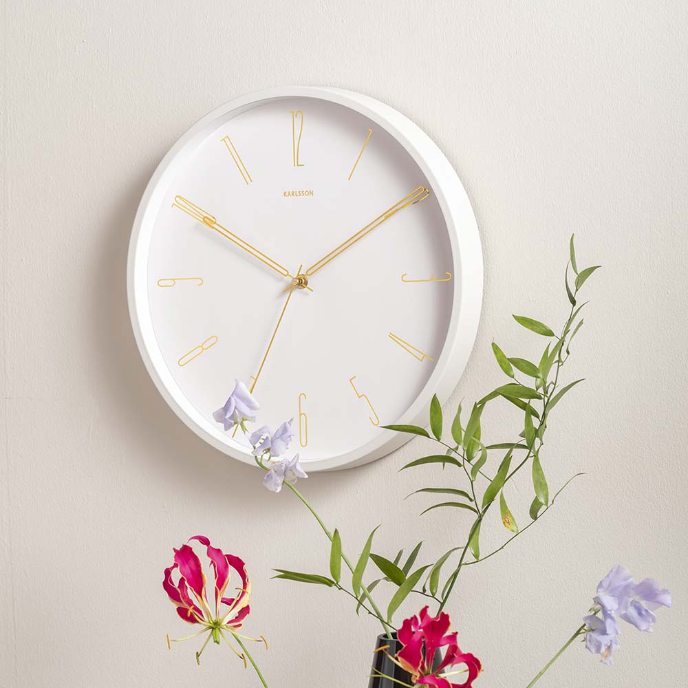 Karlsson Belle Numbers Wall Clock White hanging on a wall with flowers at House