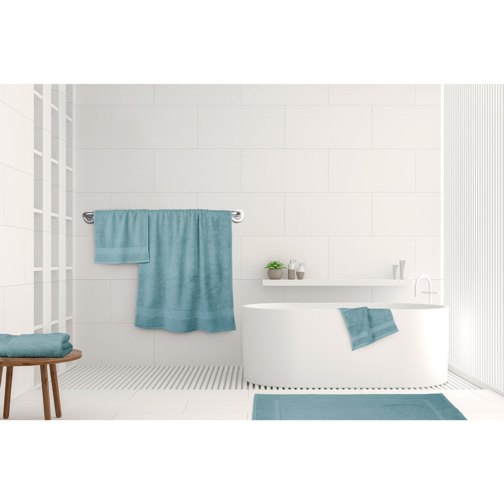 Algodon St Regis Bath Towels Mist blue blue at House. Bath towel, bath sheet, bath mat, hand towel and facewasher displayed in a bathroom