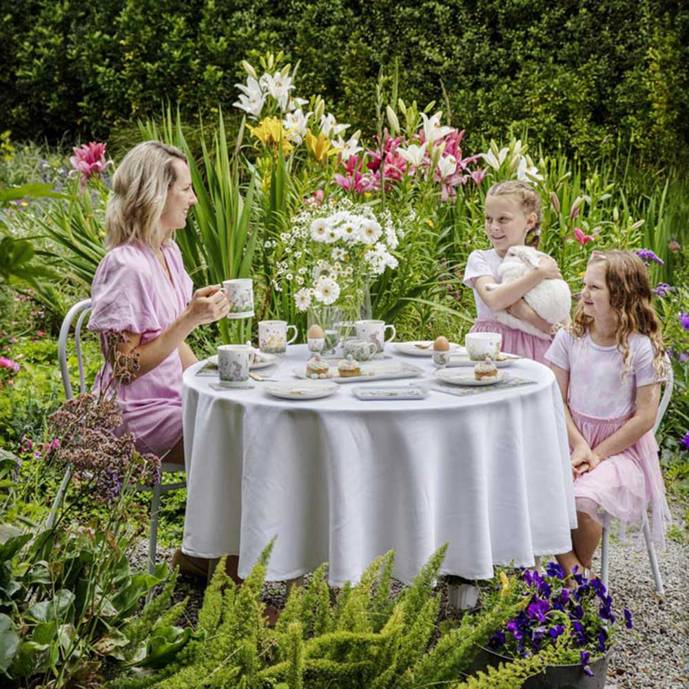 Family around the dining table outside -Ashdene Sweet Meadows Collection at House