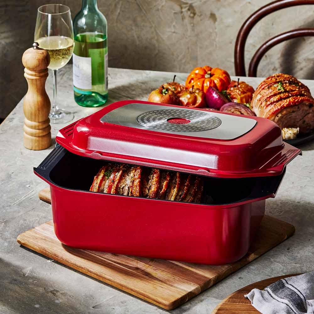 Bessemer Non Stick Roaster & Grill 34cm Red at House on a wooden board with roast pork and vegetables