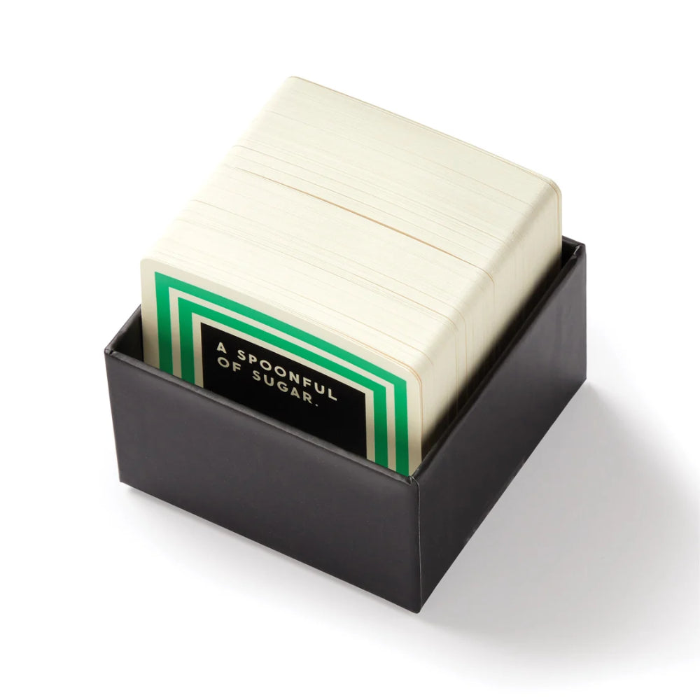 The open box of trivia cards in a black square box.