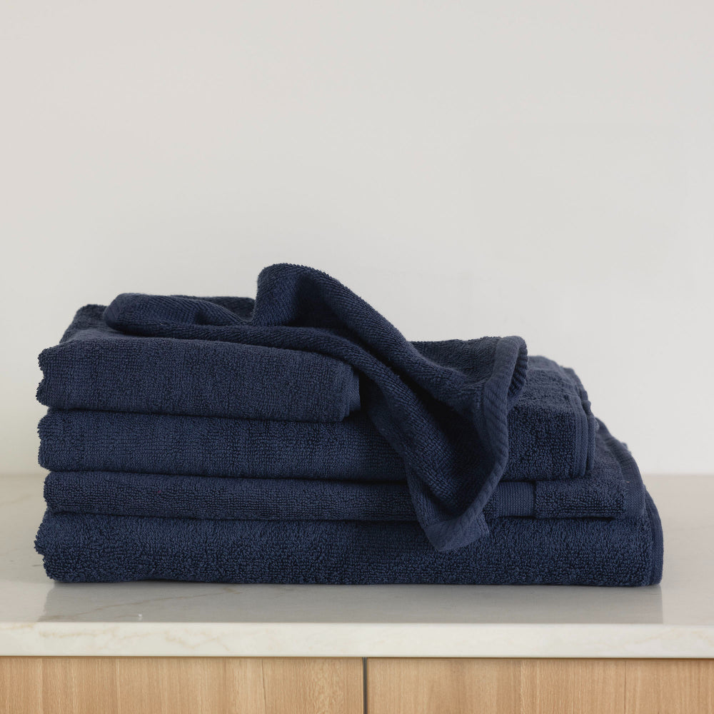 The Bambury Chateau bath sheet set in navy folded showing the different items across the range together.