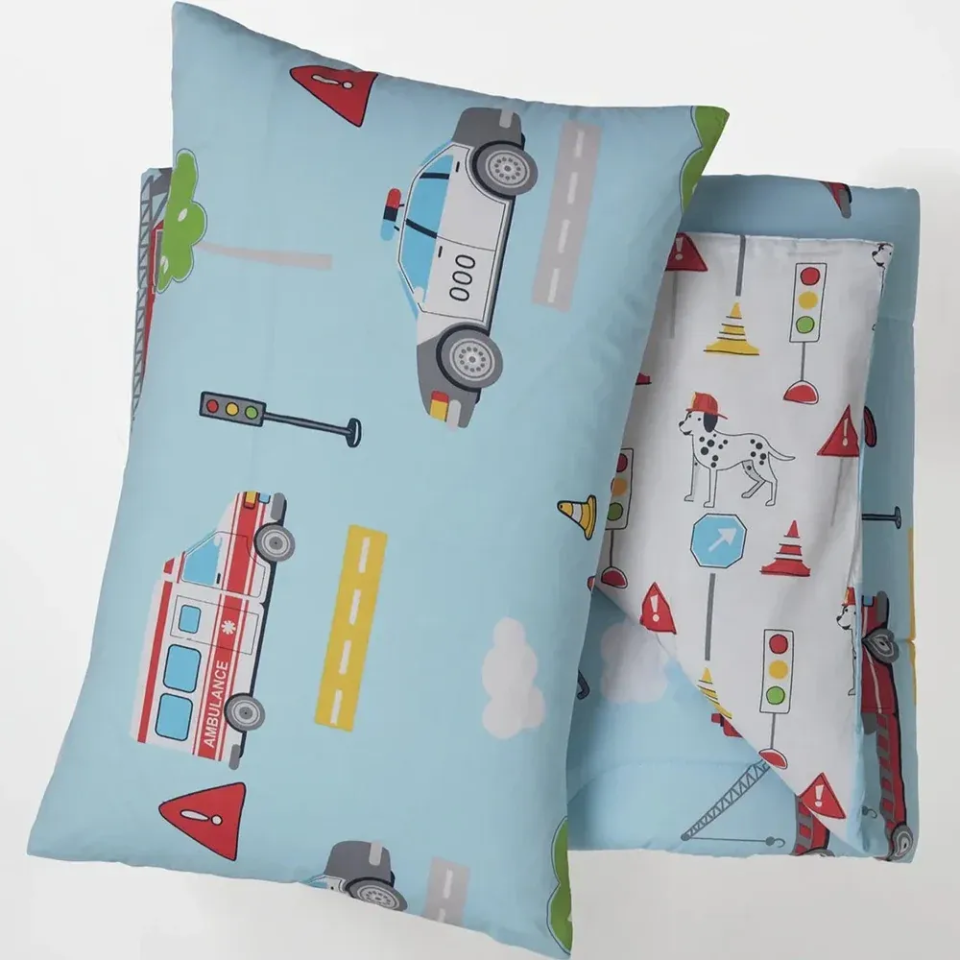 Two pillows with vehicle-themed patterns on a light blue background
