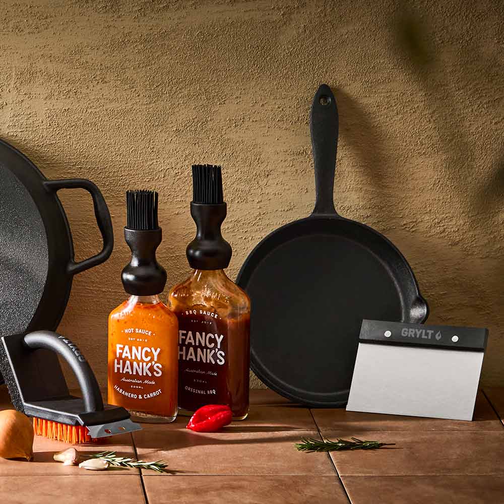 cast iron pans and stainless steel utensils for outdoor cooking - House