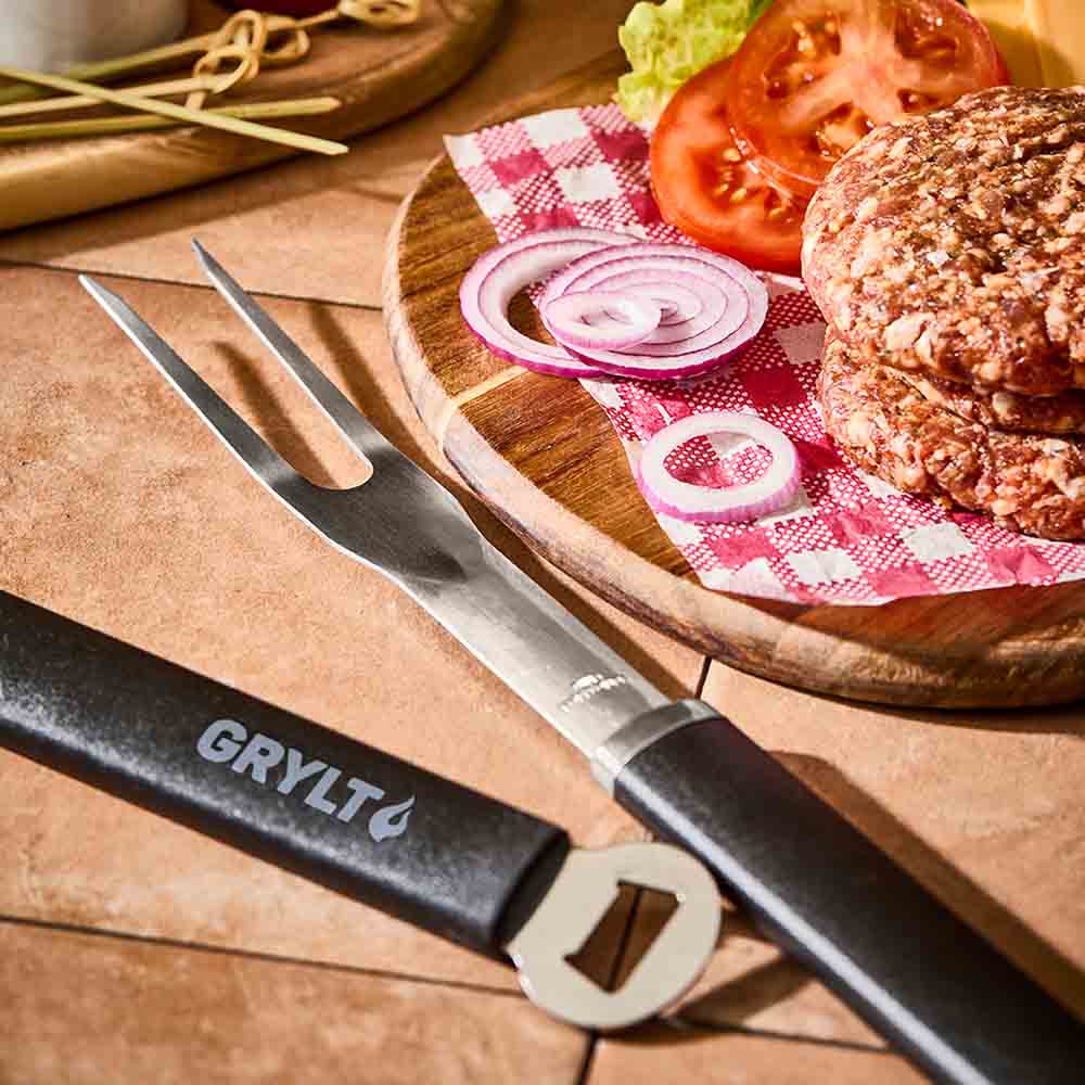 stainless steel BBQ fork next to burger patties - House