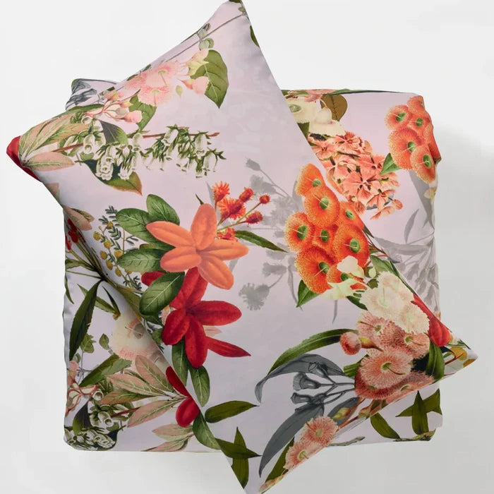 Two floral-patterned pillows on a light gray background