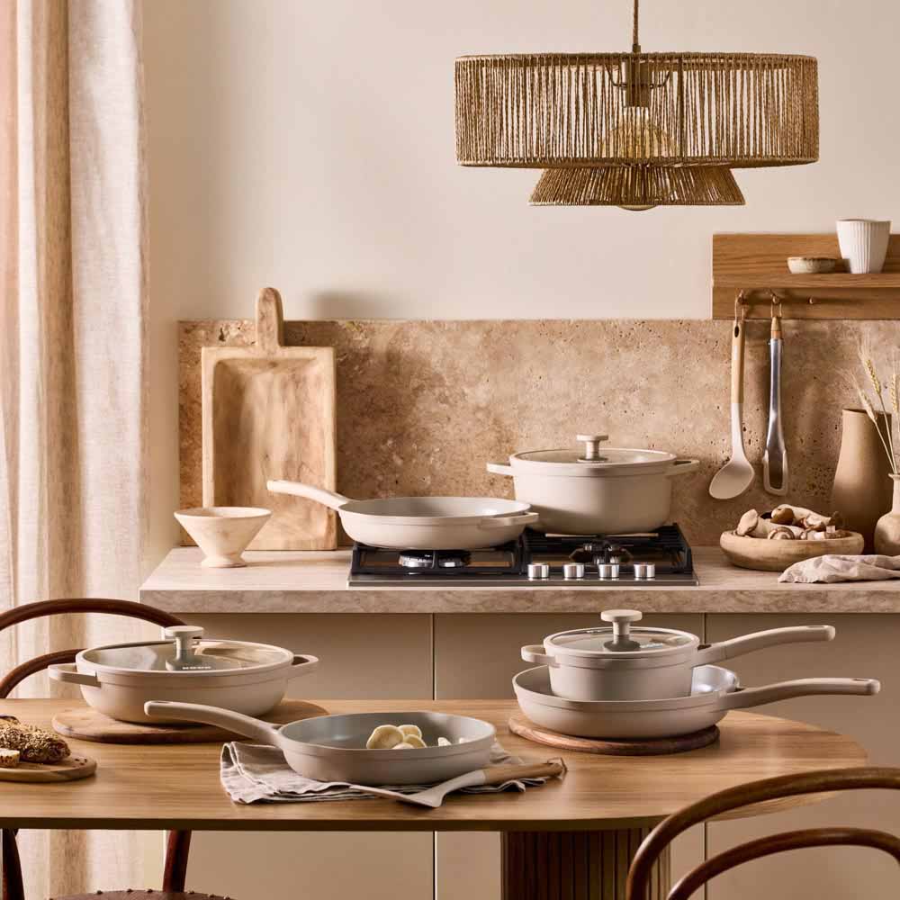 range of cream frypans, saucepans and utensils