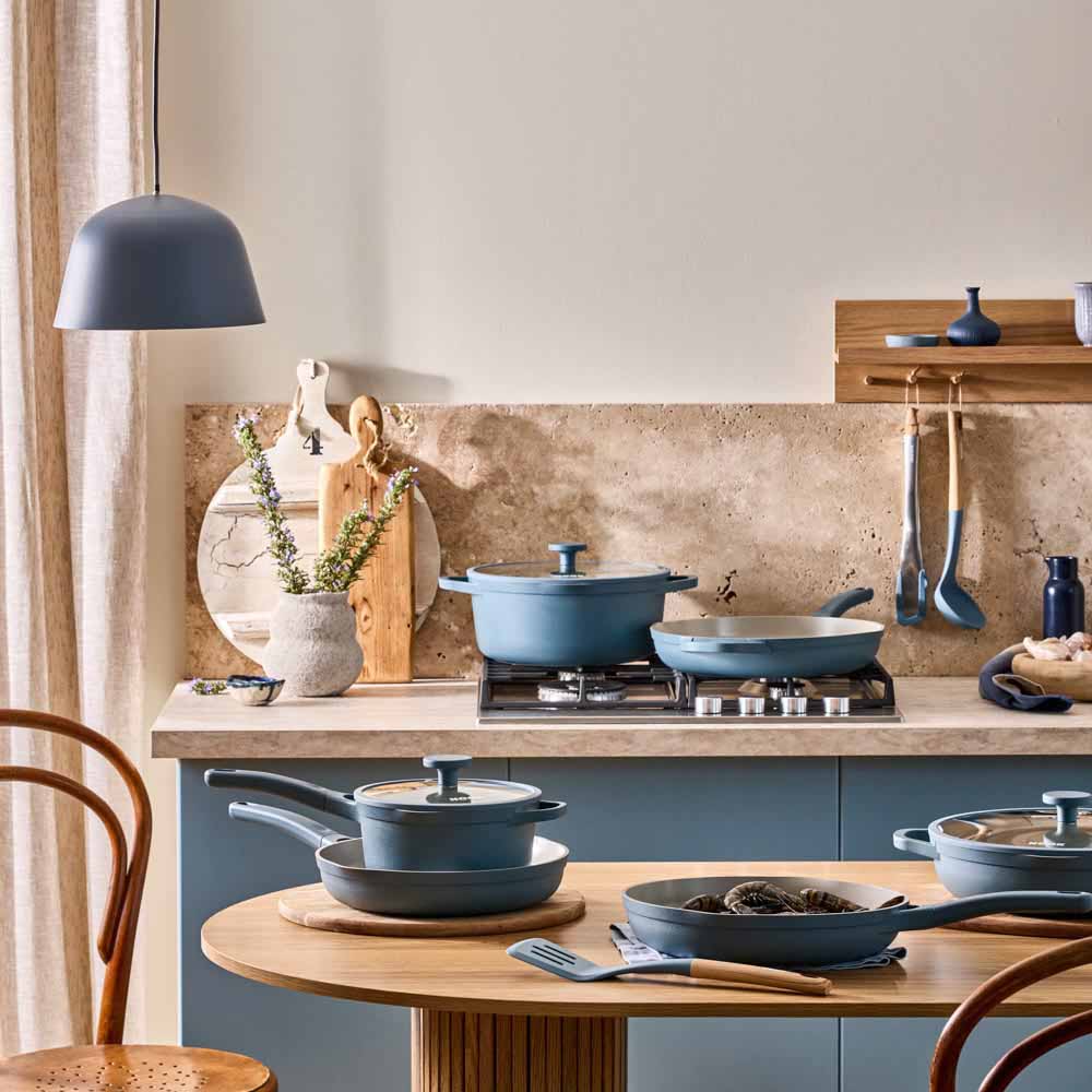 range of blue cookware, frypans and saucepans in a blue theme kitchen