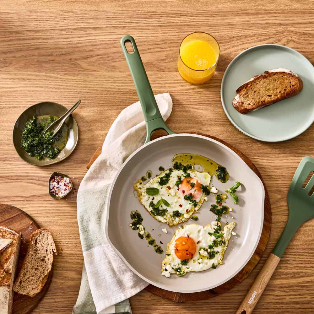 fried eggs with chimchurri in a green frypan