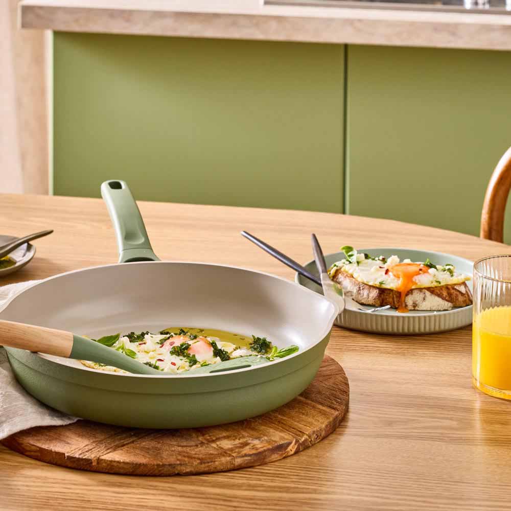 fried eggs with chimchurri in a green frypan