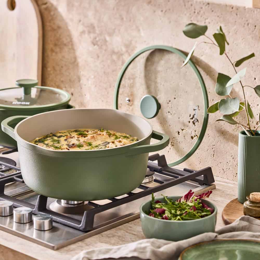 fish stew in a green casserole pot with lid