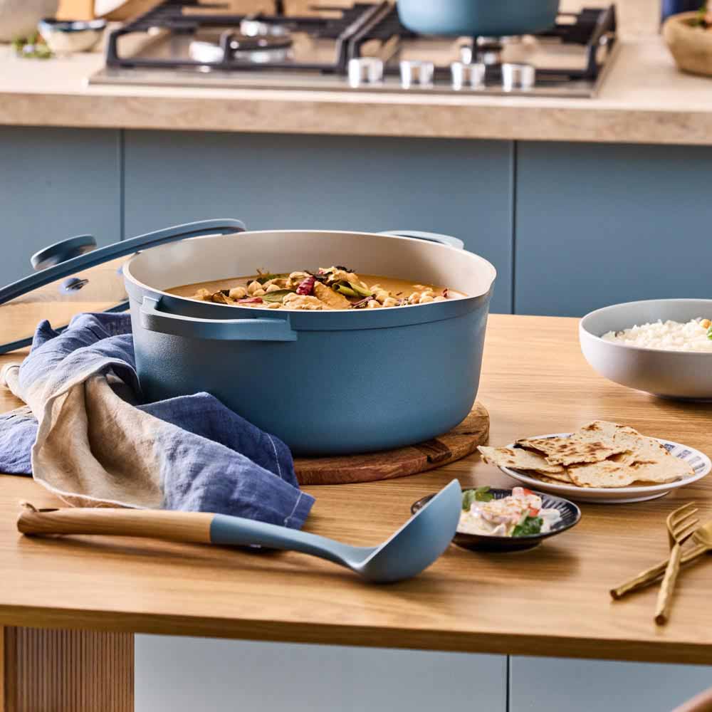 red dahl served from a blue casserole pot on the stove