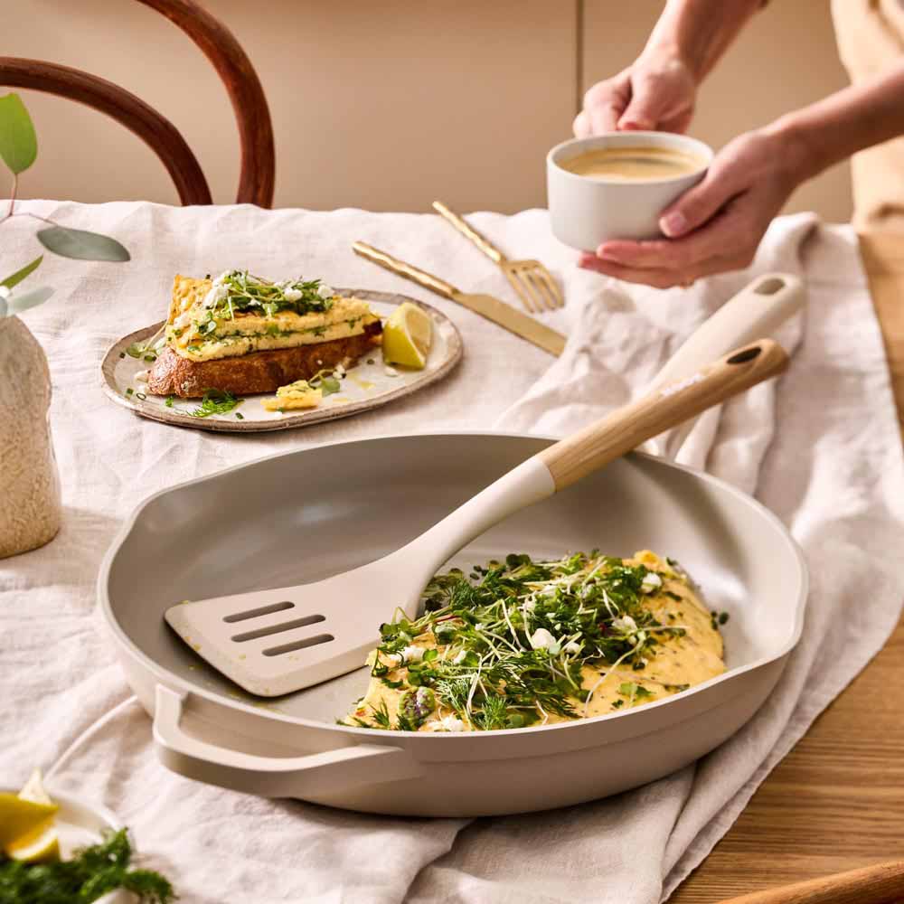 omelette served in cream frypan with cream utensil
