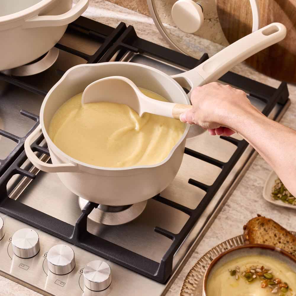 french onion soup served from a cream saucepan