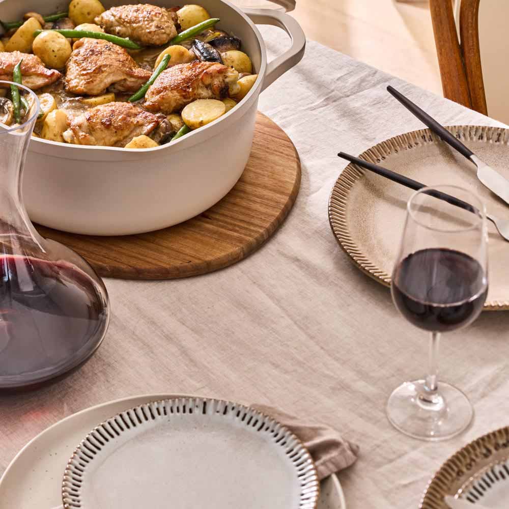 chicken and potato stew served from a cream casserole pot