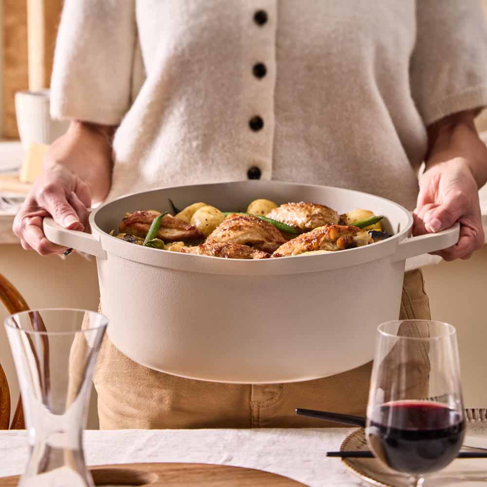 chicken and potato stew served from a cream casserole pot
