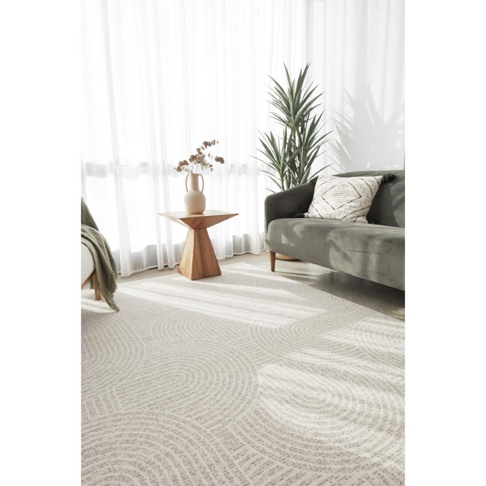 natural colour wool rug with arch design in a sun drenched room - House