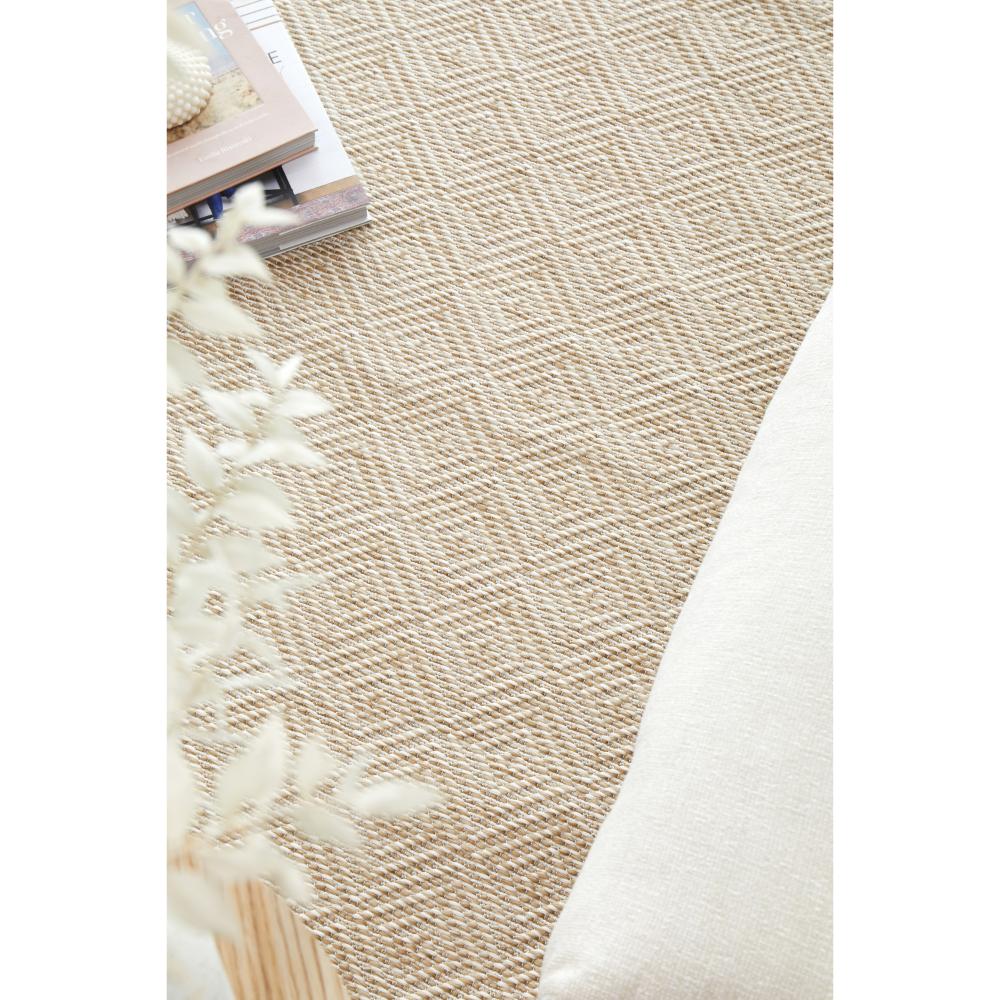 Beige brown diamond design indoor outdoor rug with stack of books - House