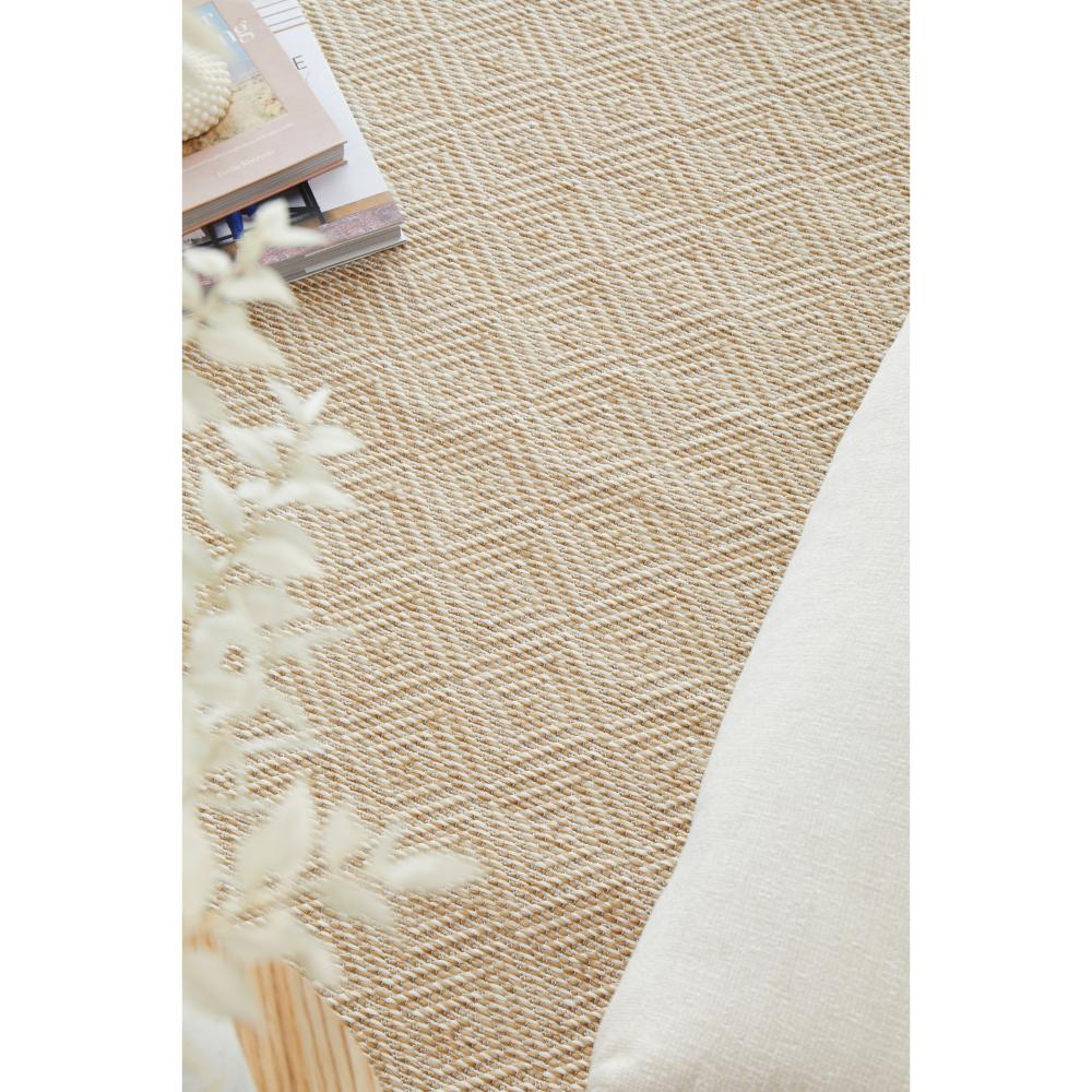 Beige diamond design Indoor/Outdoor rug with stack of books - House