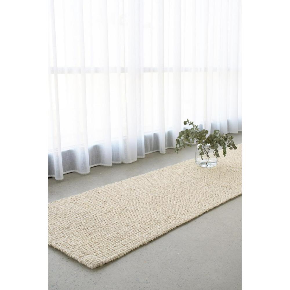 cream beige Hamptons style jute wool rug by a window - House