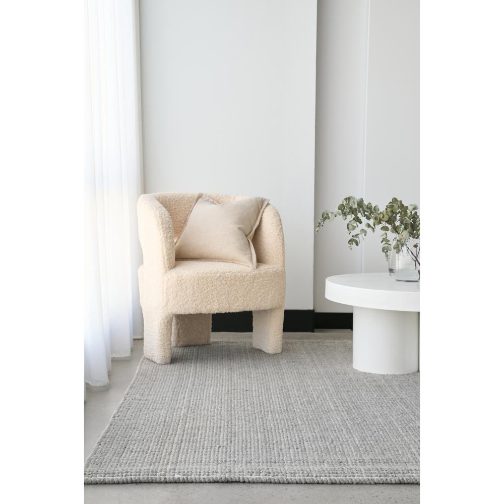 grey hamptons style jute wool rug with boucle chair - House