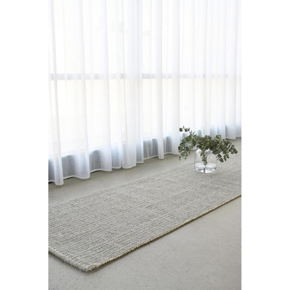 grey Hamptons style jute wool rug by a window - House