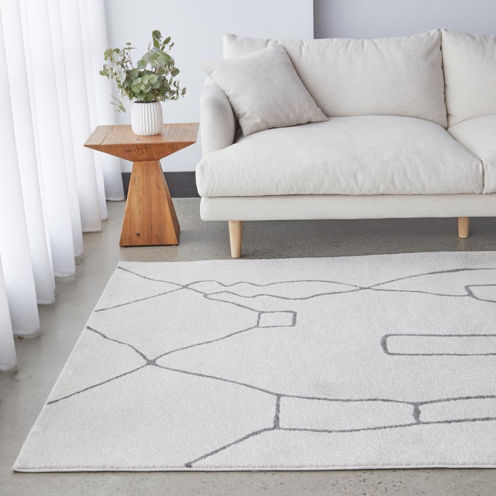 grey modern abstract rug with lounge and wooden side table - House