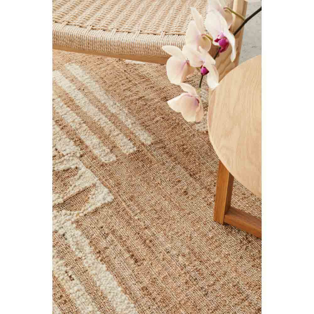 warm beige jute bohemian rug with chair and orchid - House