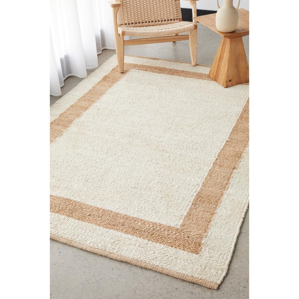 cream jute rug with beige border with armchair - House